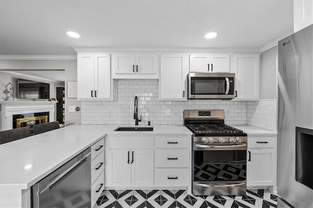 kitchen featuring kitchen peninsula, sink, white cabinets, and appliances with stainless steel finishes