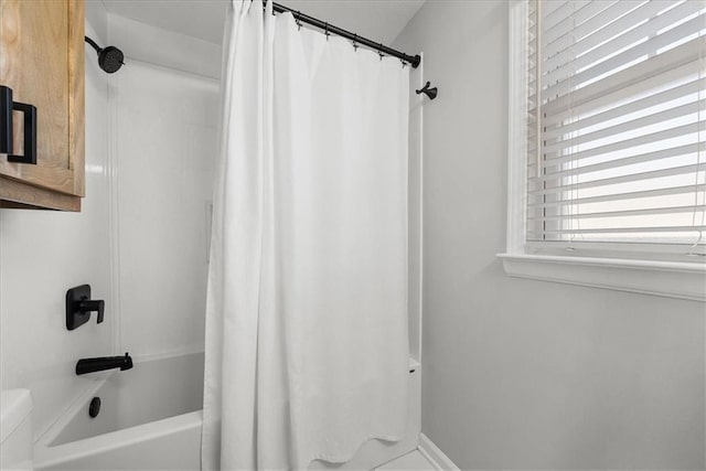 bathroom with shower / bath combo with shower curtain