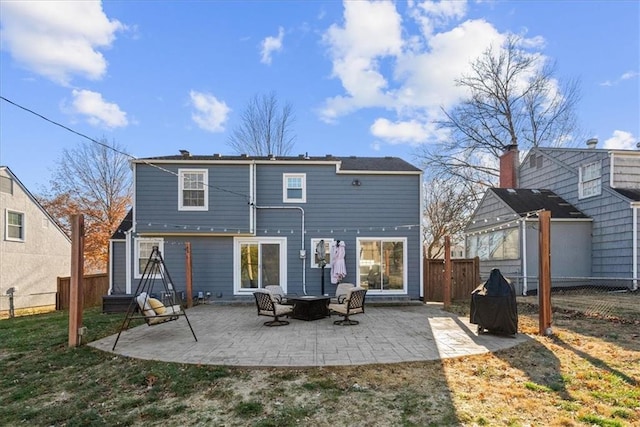 back of property featuring a yard and a patio