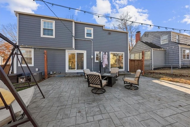 back of property with a patio and cooling unit