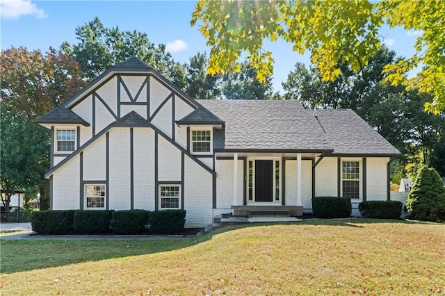 tudor house featuring a front lawn