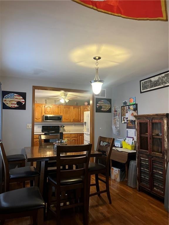 dining room featuring dark hardwood / wood-style floors and ceiling fan