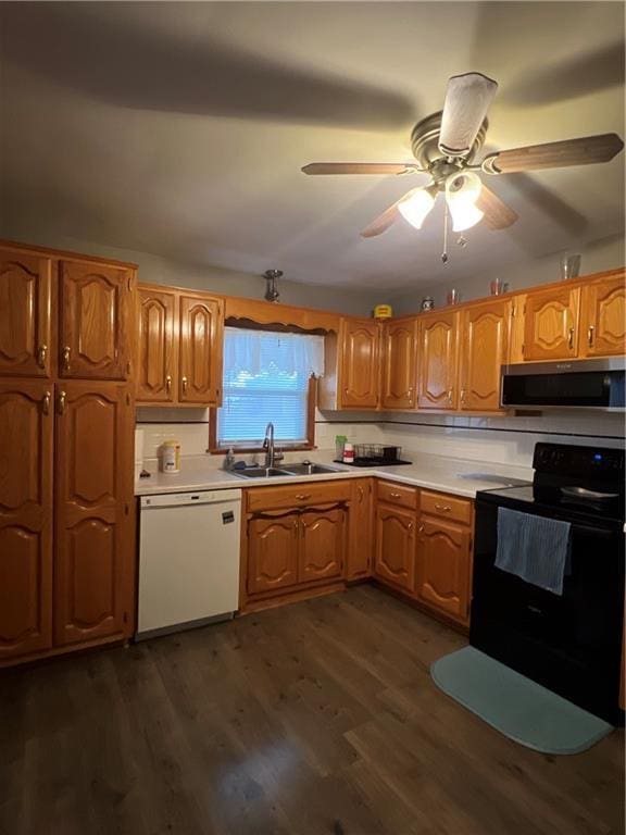 kitchen featuring white dishwasher, ceiling fan, dark wood-type flooring, sink, and black range with electric stovetop