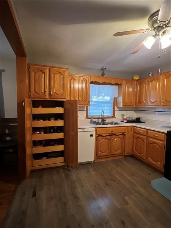 kitchen with dishwasher, sink, dark hardwood / wood-style floors, decorative backsplash, and ceiling fan