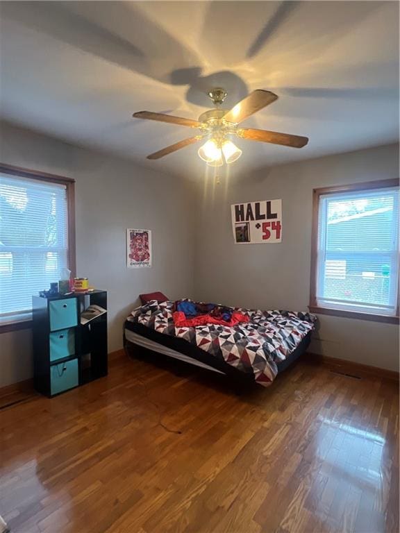 bedroom featuring hardwood / wood-style floors and ceiling fan