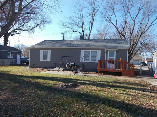 rear view of house featuring a lawn, a patio area, and a wooden deck