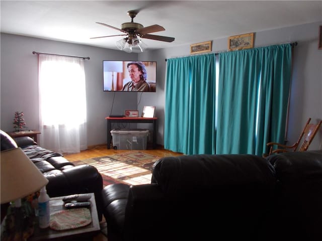 living room with ceiling fan and light hardwood / wood-style flooring