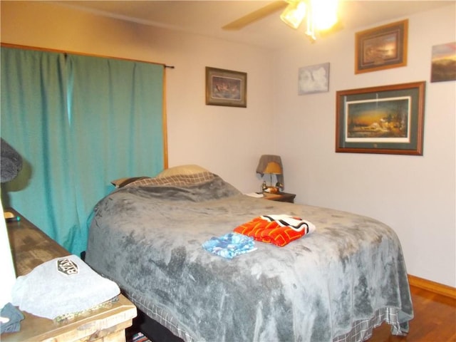 bedroom with ceiling fan and wood-type flooring