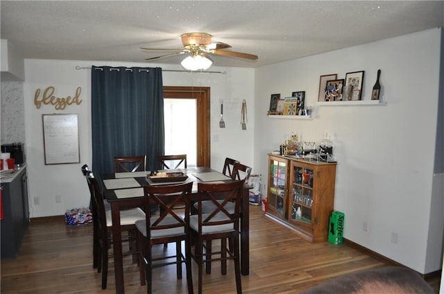 dining space with dark hardwood / wood-style flooring and ceiling fan