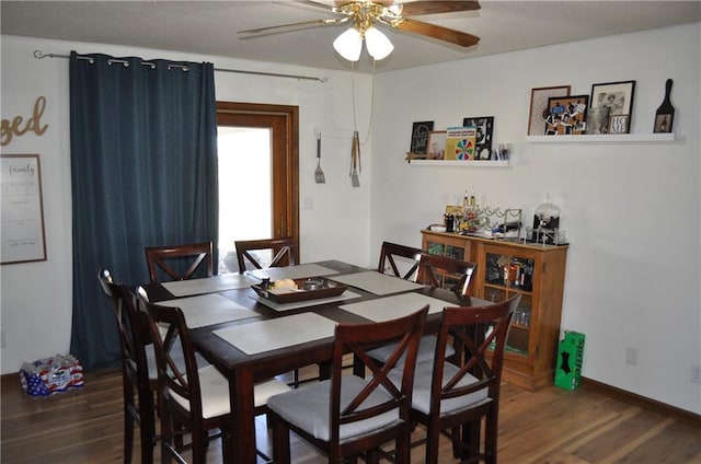 dining room with dark hardwood / wood-style floors and ceiling fan