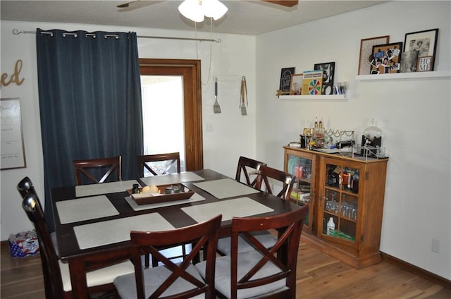 dining room with ceiling fan and wood-type flooring