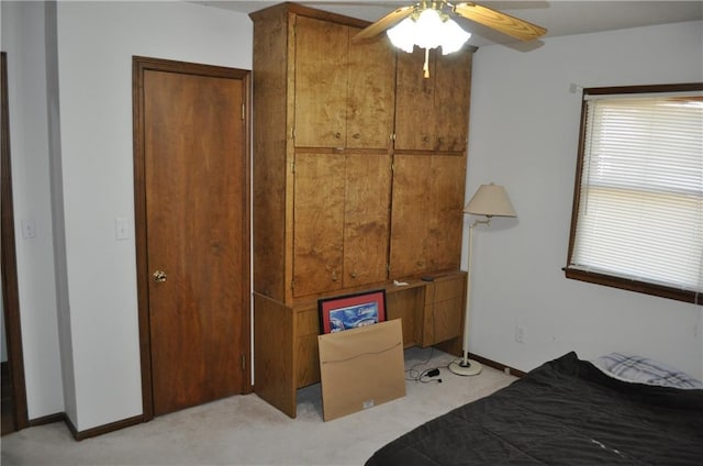 bedroom with ceiling fan and light colored carpet