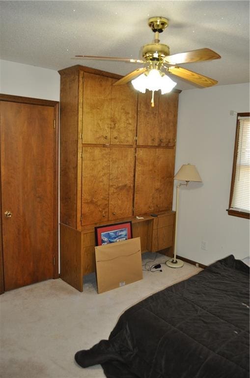 bedroom featuring ceiling fan, a closet, and light colored carpet