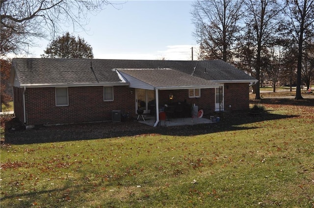 back of house featuring a lawn and a patio