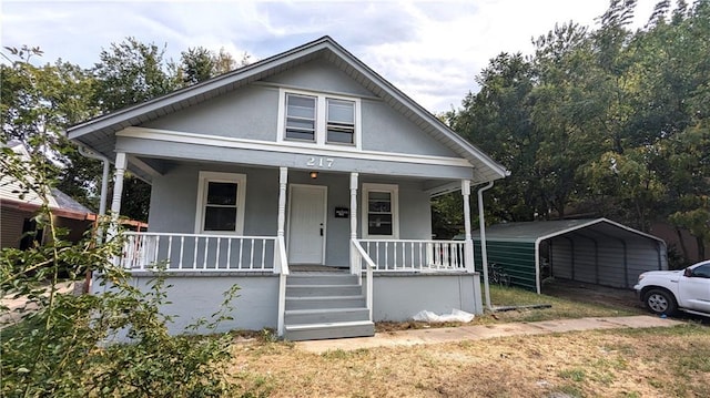 bungalow featuring covered porch and a carport