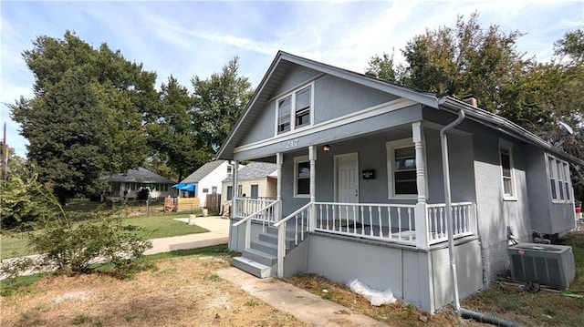 view of front of home with cooling unit and a porch