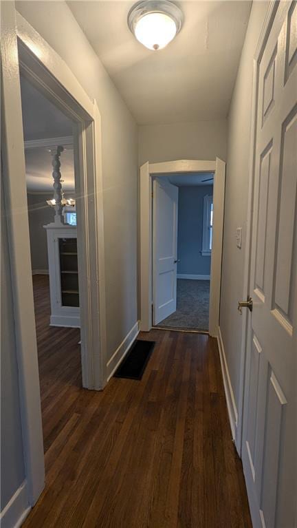 corridor with dark hardwood / wood-style flooring