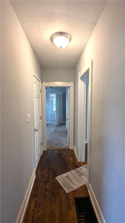 hallway with dark wood-type flooring