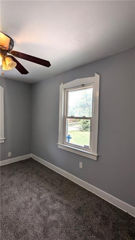 unfurnished room featuring carpet floors and ceiling fan