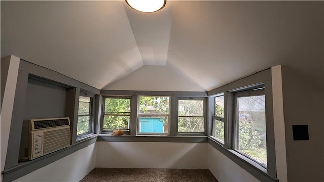 unfurnished sunroom with cooling unit, lofted ceiling, and a wealth of natural light