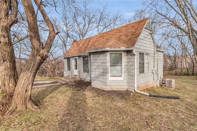 view of property exterior featuring cooling unit and a yard