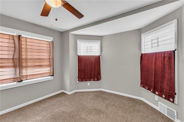 carpeted spare room with ceiling fan