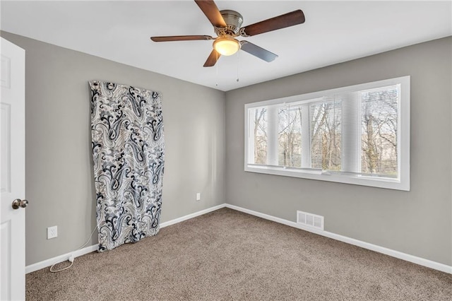 spare room with carpet floors and ceiling fan