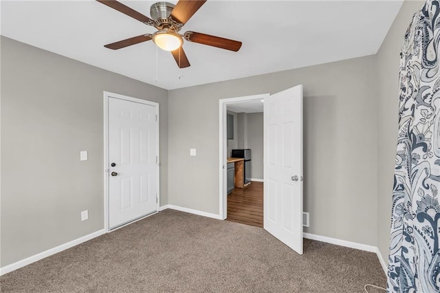 unfurnished bedroom featuring ceiling fan, a closet, and carpet floors