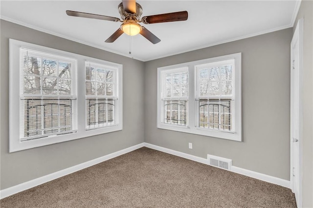 unfurnished room with plenty of natural light, carpet, and ornamental molding