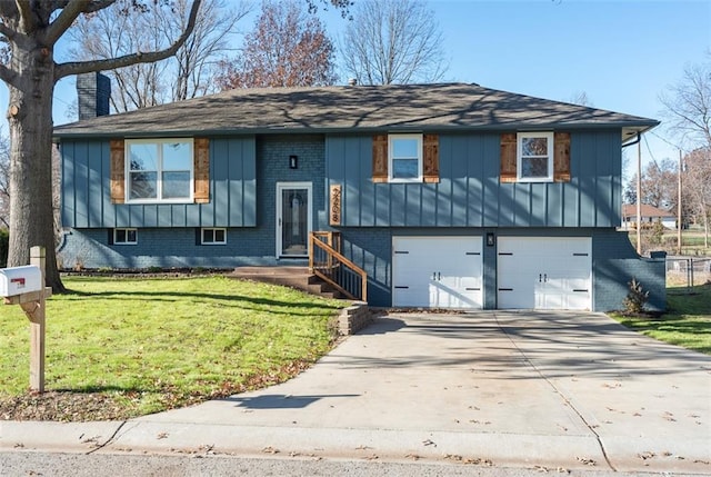 split foyer home featuring a garage and a front lawn