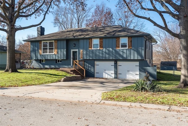 view of front of house featuring a garage and a front lawn