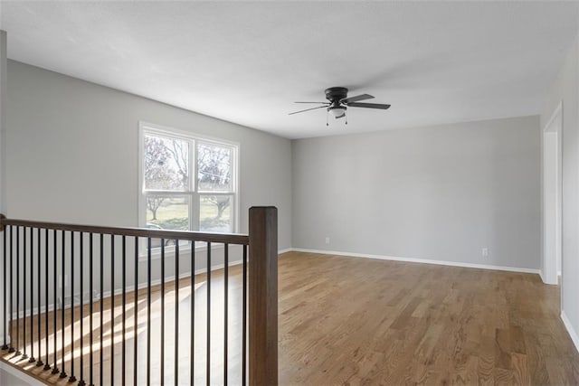 empty room featuring ceiling fan and wood-type flooring