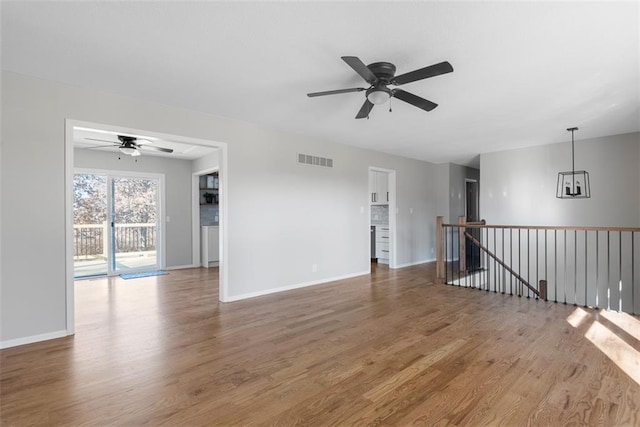 empty room with ceiling fan and wood-type flooring