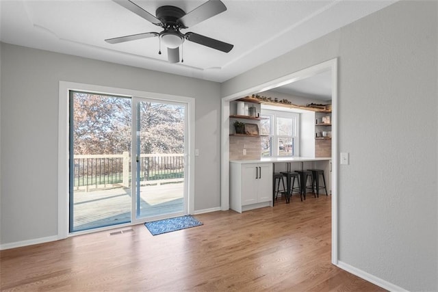 entryway with ceiling fan and light hardwood / wood-style floors