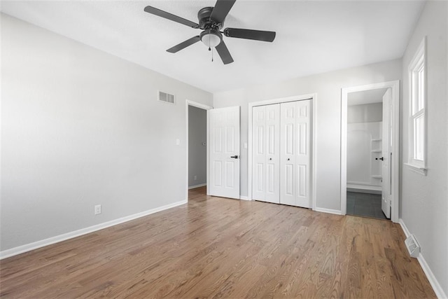 unfurnished bedroom with ceiling fan, light hardwood / wood-style flooring, and ensuite bath