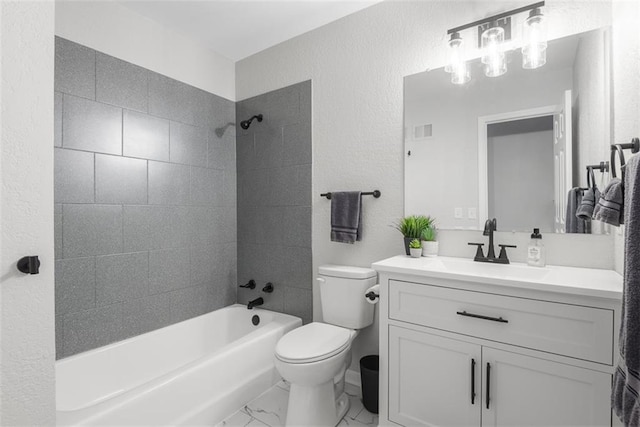 full bathroom featuring vanity, toilet, and tiled shower / bath