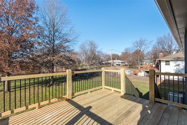 wooden terrace featuring a lawn