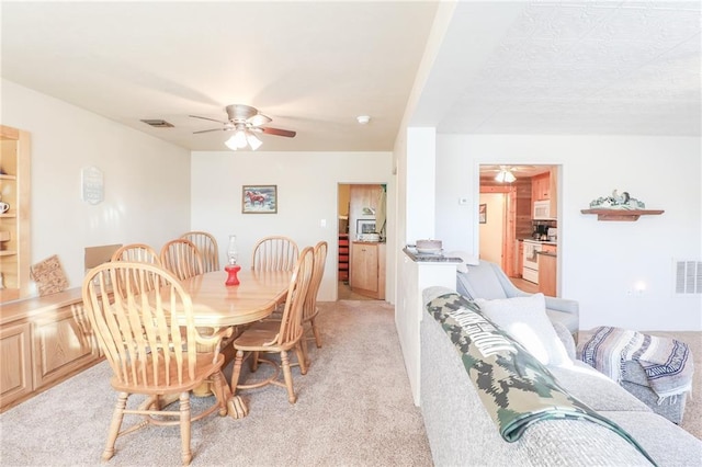 dining space with light carpet