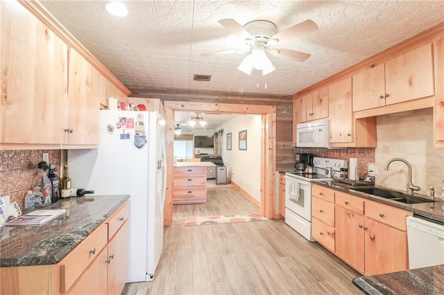 kitchen featuring light brown cabinetry, sink, white appliances, and light wood-type flooring