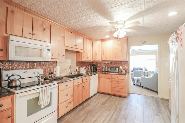 kitchen featuring light brown cabinets, white appliances, sink, light hardwood / wood-style flooring, and ceiling fan