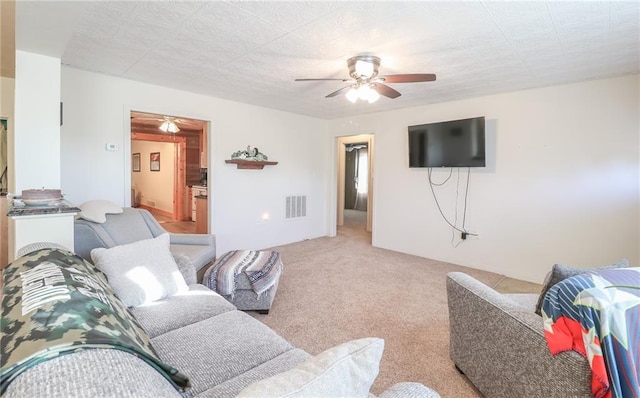 living room with ceiling fan and light carpet