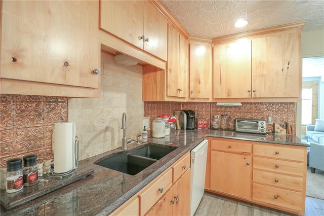 kitchen featuring dishwasher, light brown cabinetry, light hardwood / wood-style flooring, and sink