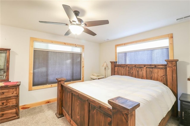 bedroom with ceiling fan and light colored carpet