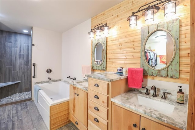 bathroom featuring hardwood / wood-style floors, vanity, and wooden walls