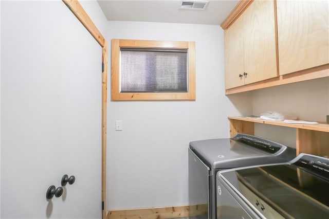 laundry room featuring cabinets and washing machine and clothes dryer