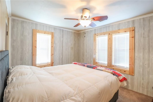 bedroom featuring ceiling fan, crown molding, and carpet floors