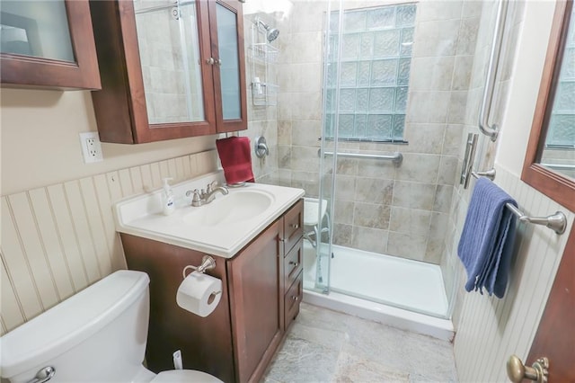 bathroom featuring vanity, toilet, and an enclosed shower