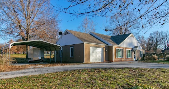 exterior space with a lawn, a garage, and a carport