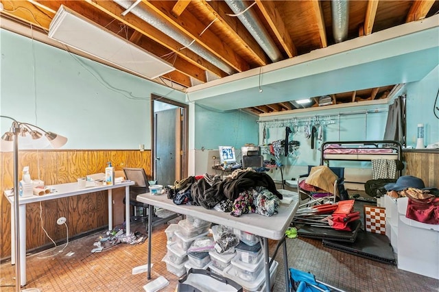 miscellaneous room featuring a wainscoted wall and wooden walls