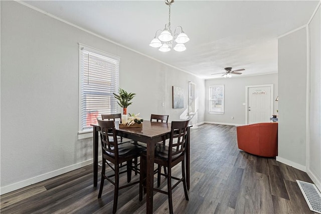 dining area featuring ceiling fan with notable chandelier, dark hardwood / wood-style floors, and ornamental molding